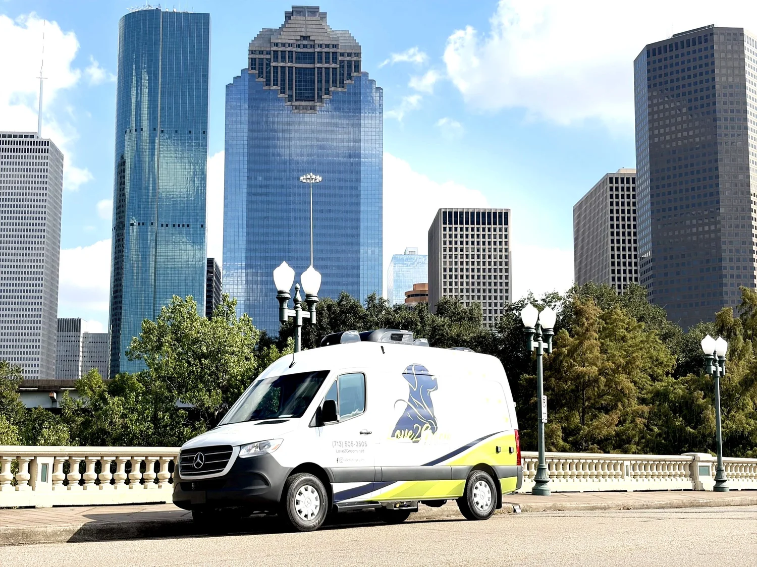 Love2Groom mobile grooming van with the Houston skyline